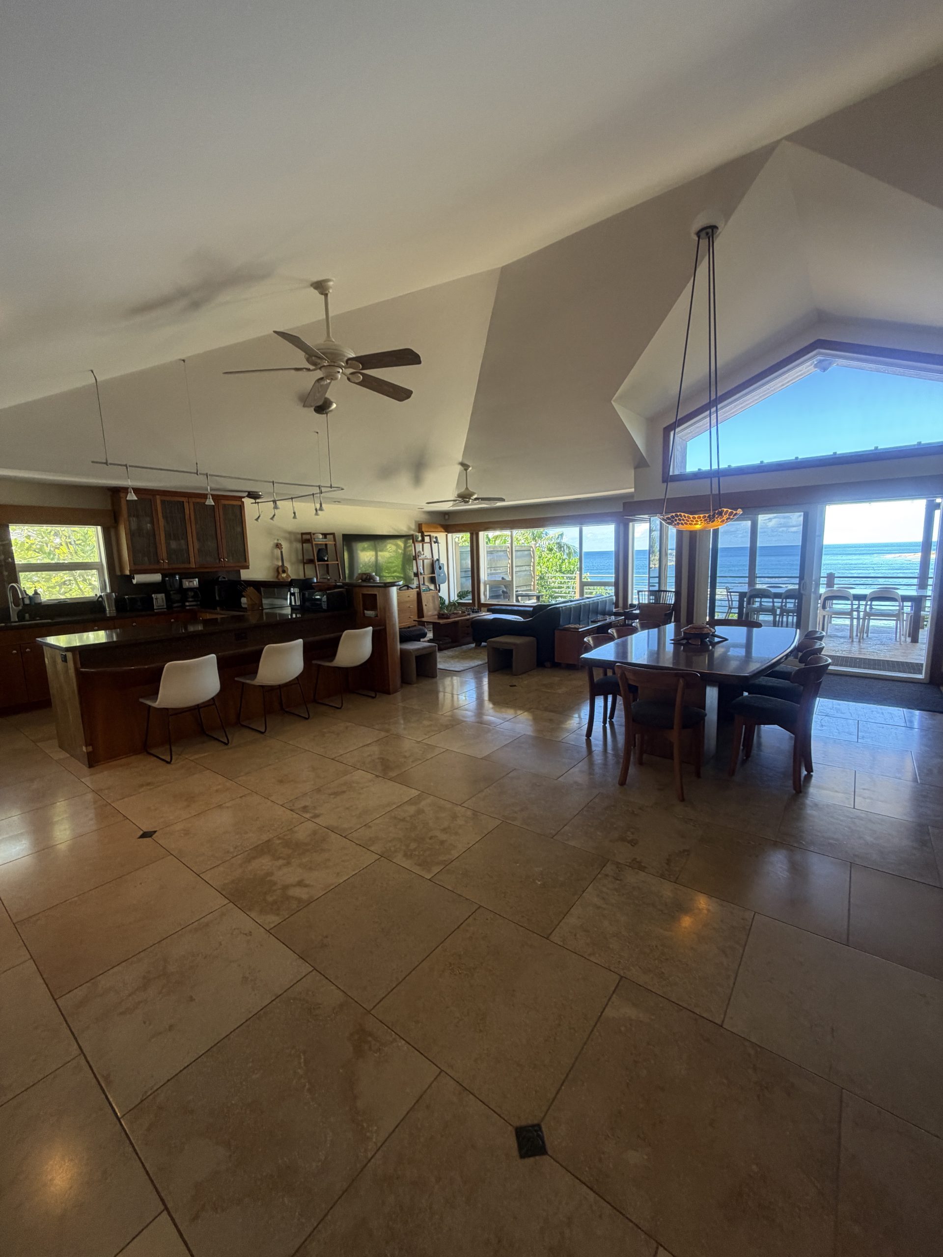 Open great room with ocean views through tall windows